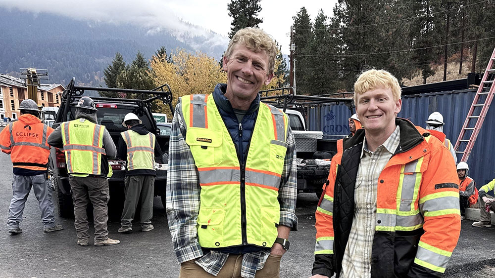 Two men smiling on a construction site