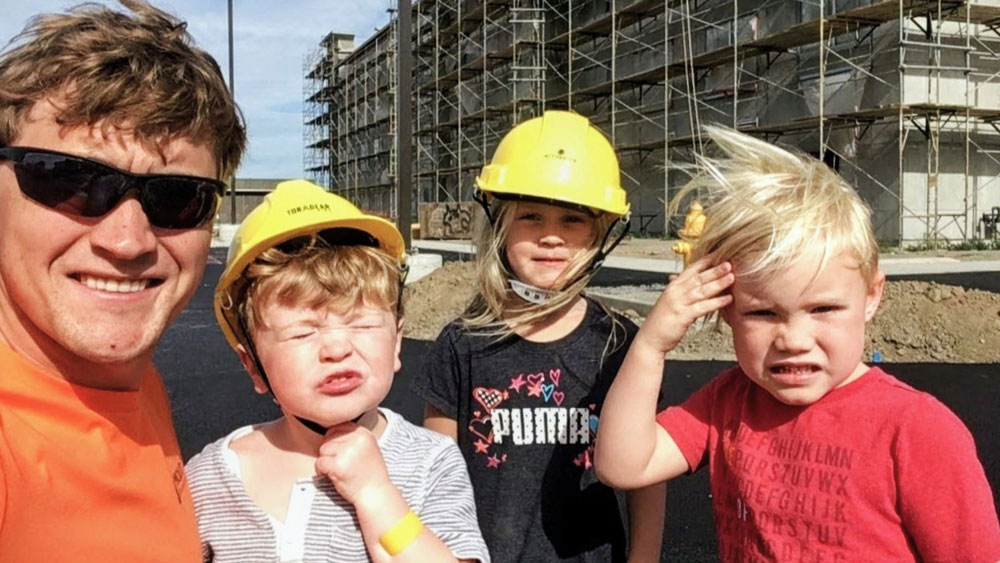 Molitor worker with kids at a construction site