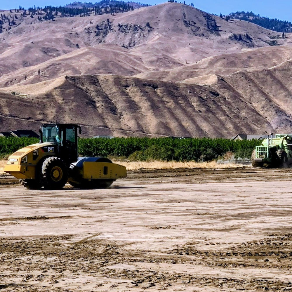 Bulldozers in front of mountains